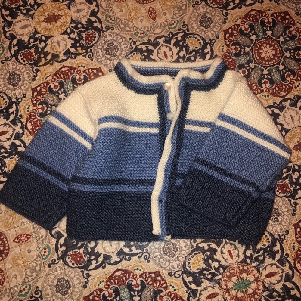 Hand-knitted baby sweater.